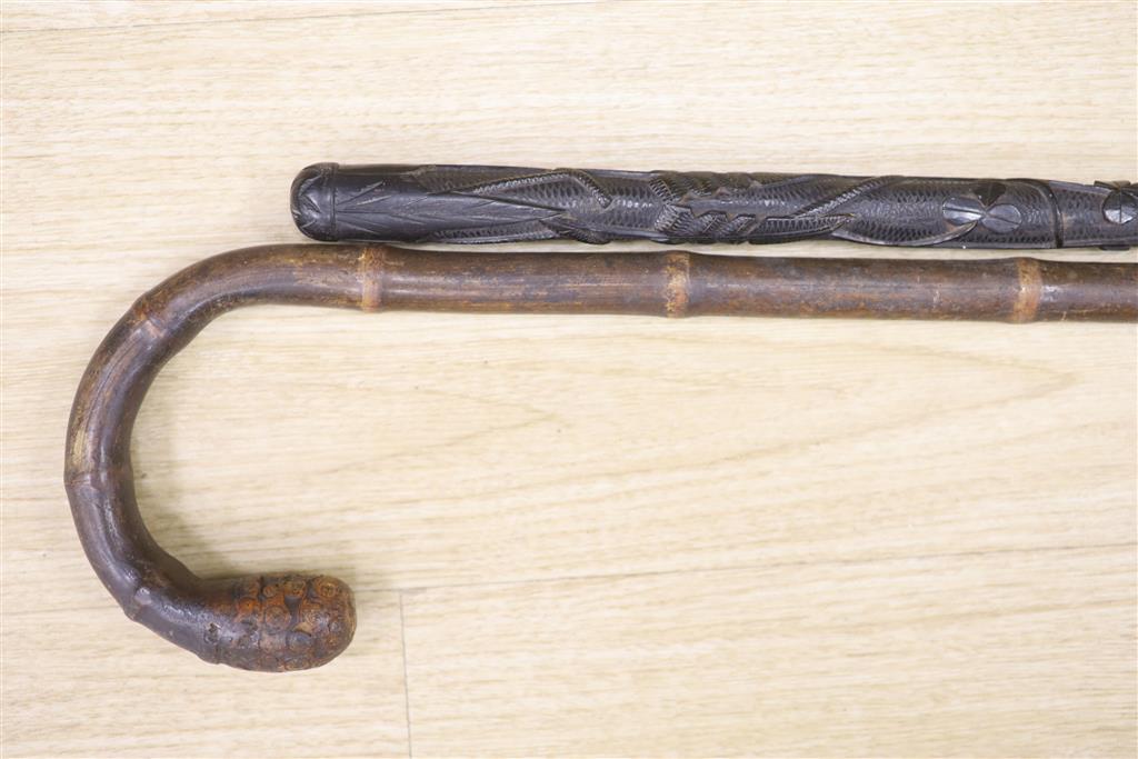 Victorian bamboo measuring stick and an Irish bog oak walking stick, longest 90cm